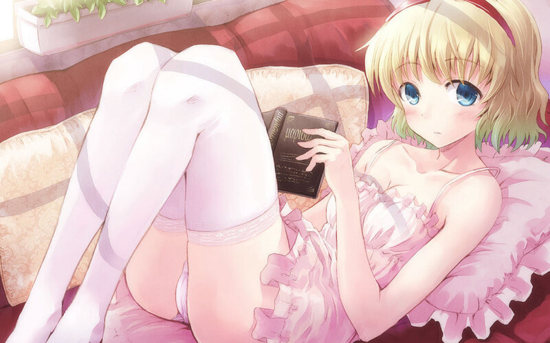 Blonde girl reading on couch