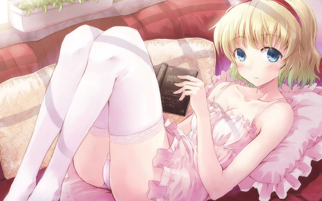 Blonde girl reading on couch