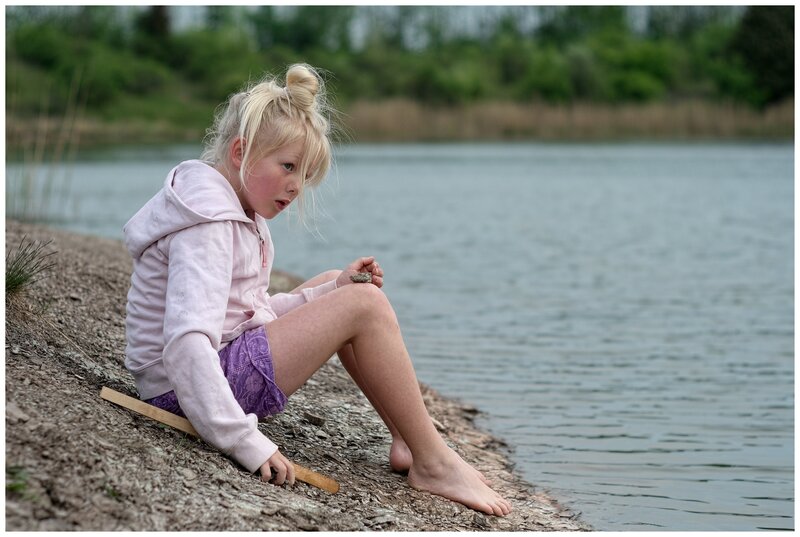 Blonde Girl Sitting by Lake