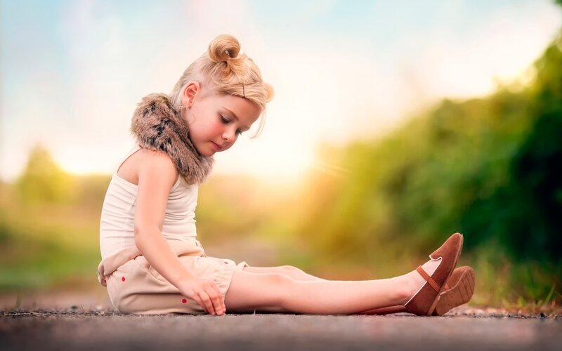 Blonde Girl Sitting on Road