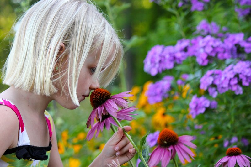 Blonde Girl Smelling Flower