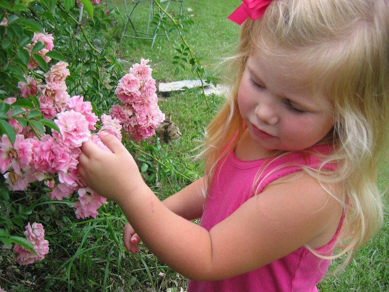 Blonde Girl Smelling Flowers