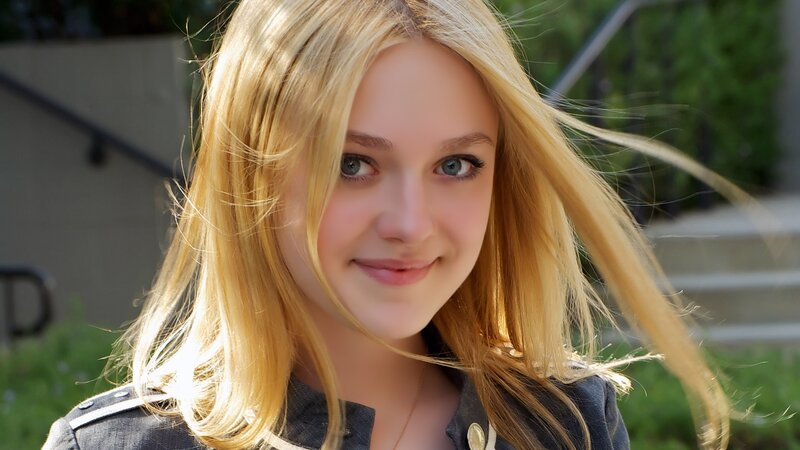 blonde girl smiling outdoors