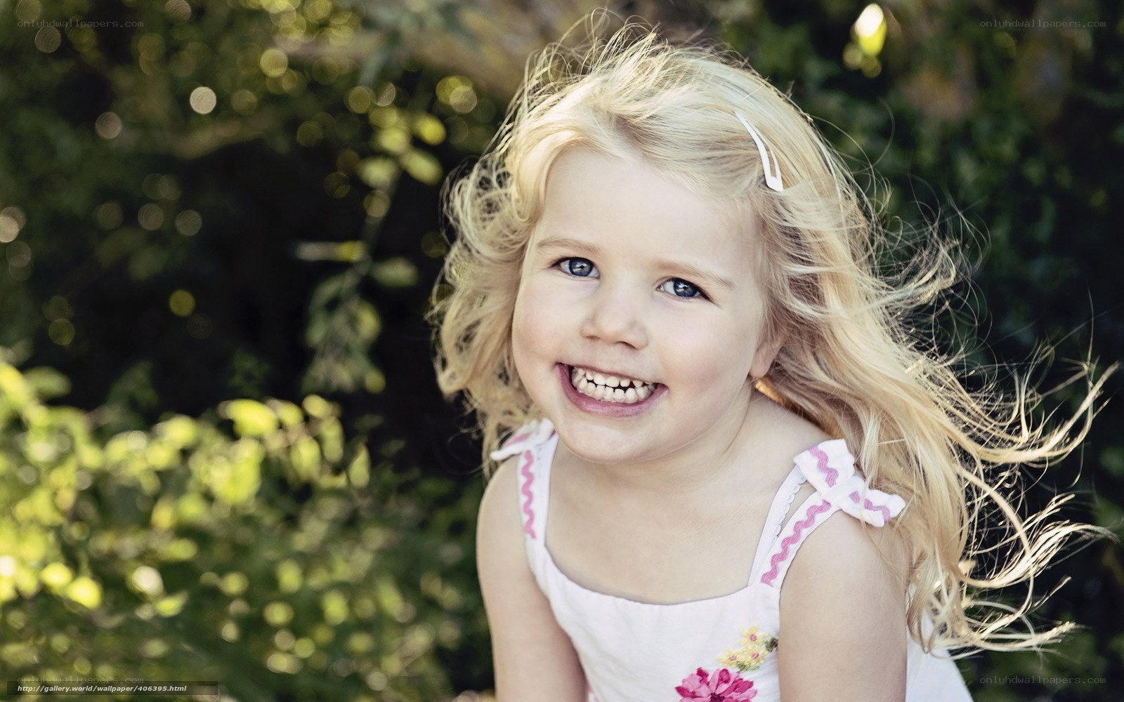 blonde girl smiling outdoors