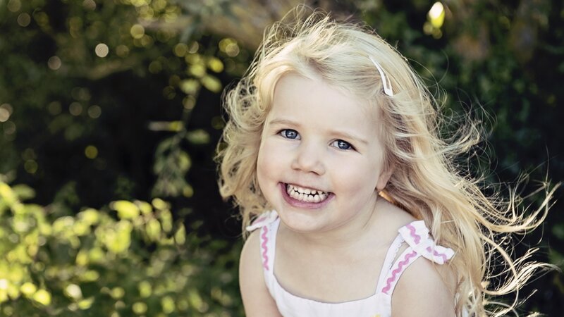 Blonde Girl Smiling — White