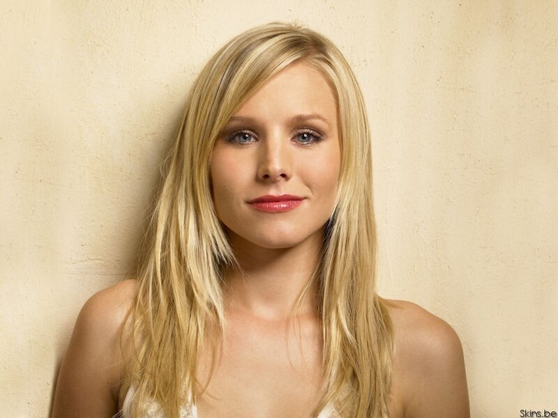 blonde woman against beige wall