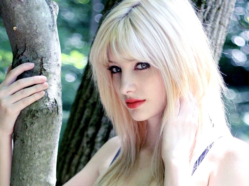 blonde woman by tree