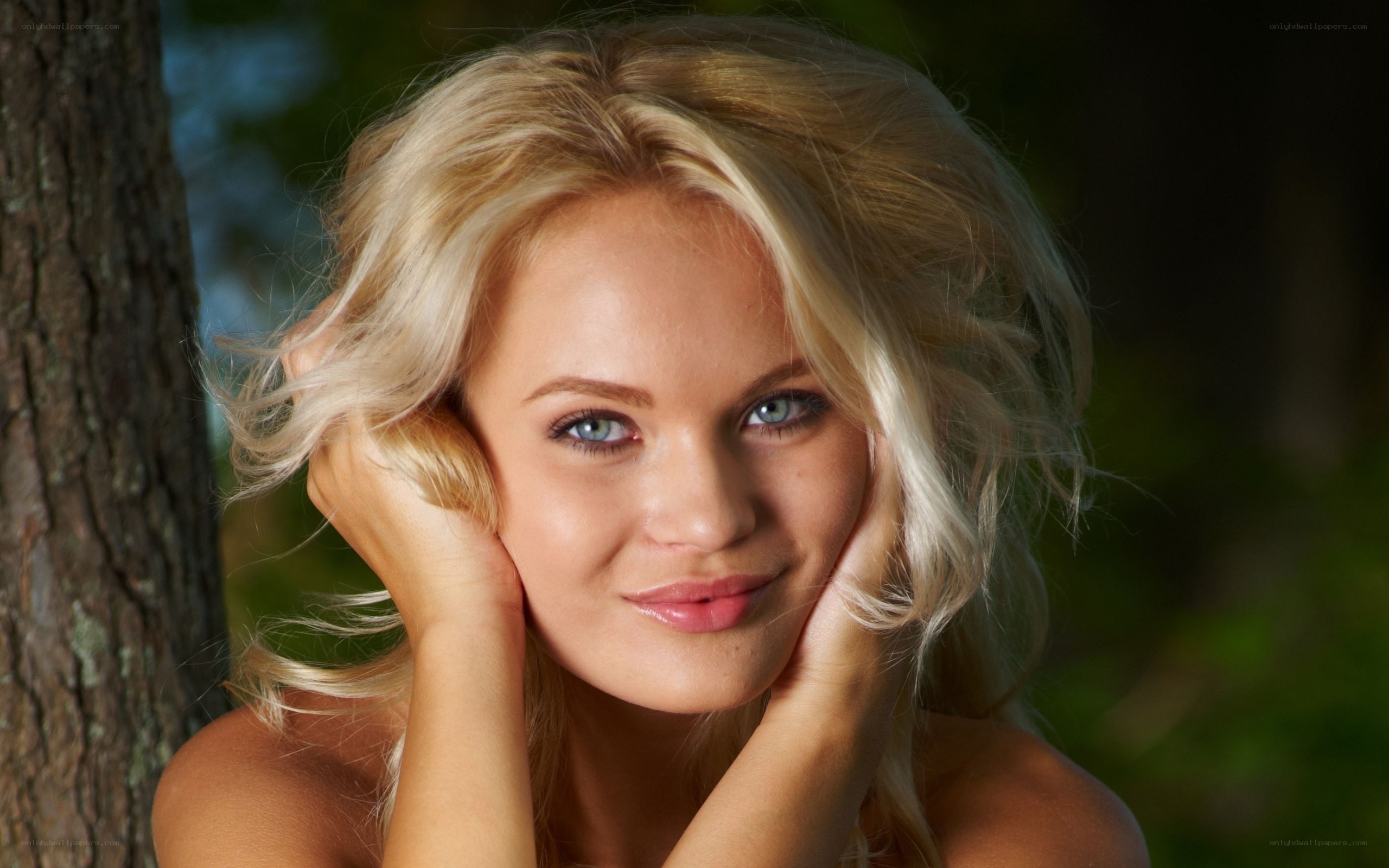 blonde woman by tree