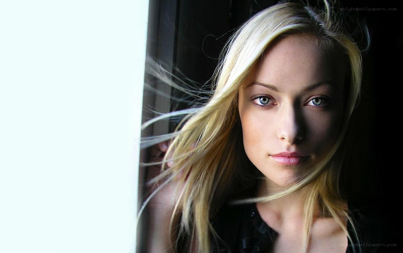 blonde woman by window