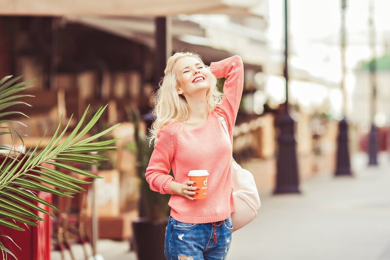 Blonde Woman Holding Coffee — Pink, Relaxed