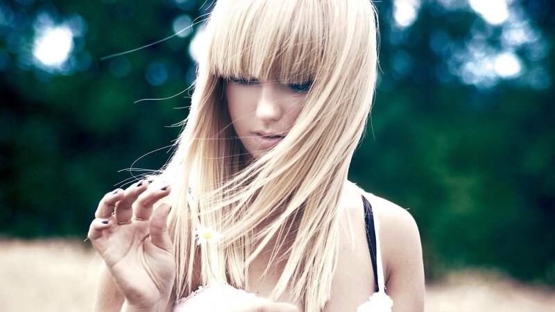 Blonde Woman Holding Daisy