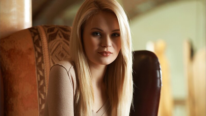 blonde woman in a chair