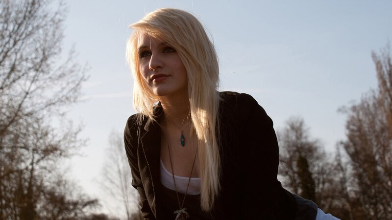 Blonde woman in black jacket