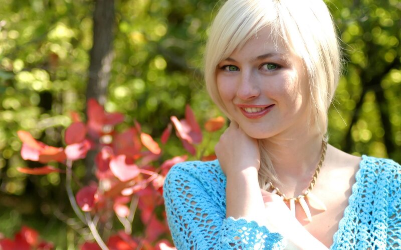 blonde woman in blue sweater