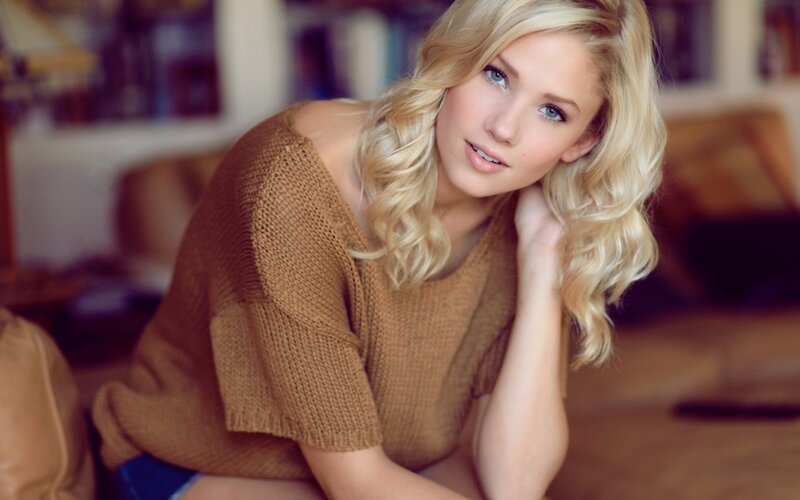 blonde woman in brown sweater