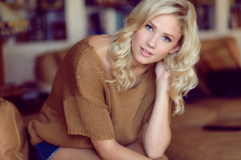 blonde woman in brown sweater