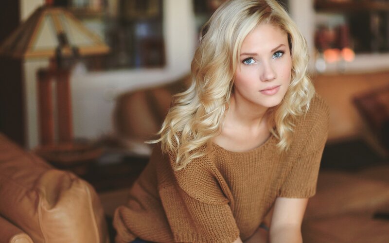 blonde woman in brown sweater