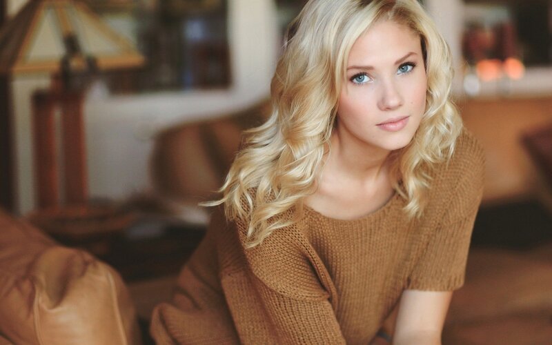 blonde woman in brown sweater