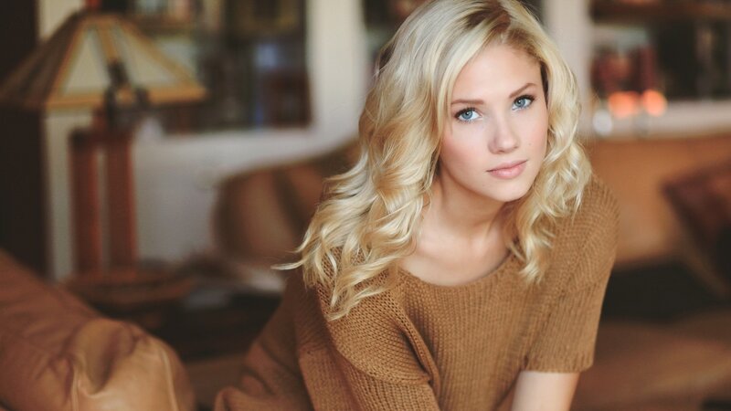 blonde woman in brown sweater