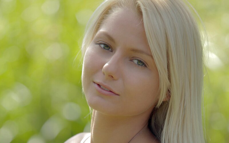 blonde woman in green field