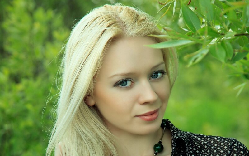 blonde woman in green setting