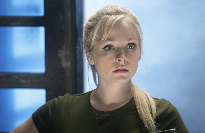 Blonde Woman in Green Shirt — Blue, Serious