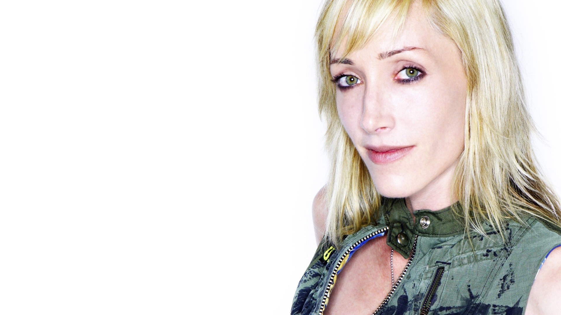 blonde woman in green vest