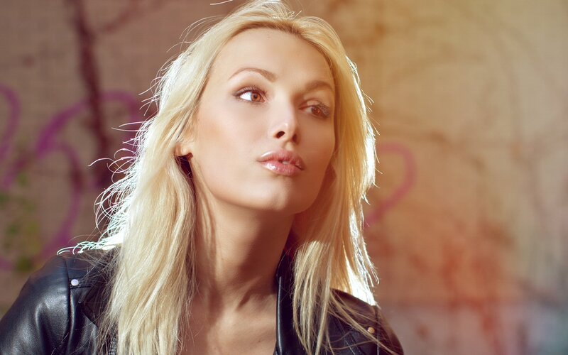 blonde woman in leather jacket