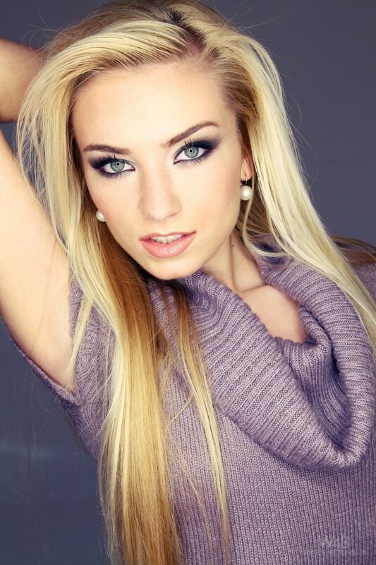 blonde woman in purple sweater