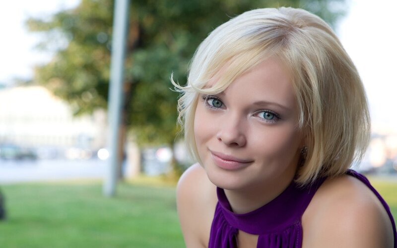 blonde woman in purple top