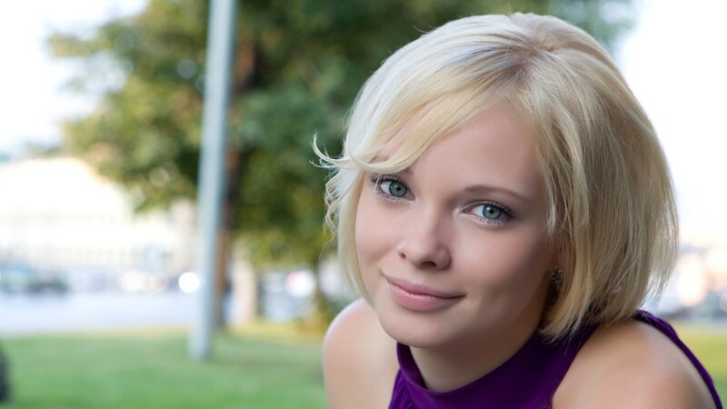 blonde woman in purple top
