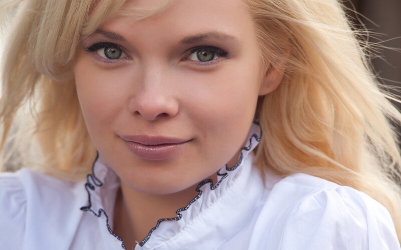 blonde woman in white blouse