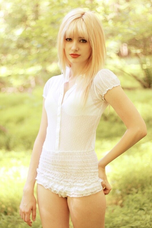 Blonde woman in white outfit
