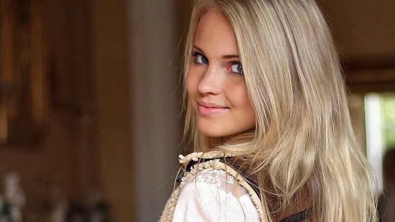 blonde woman in white top
