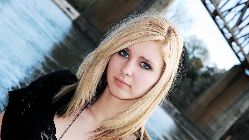 blonde woman near a bridge