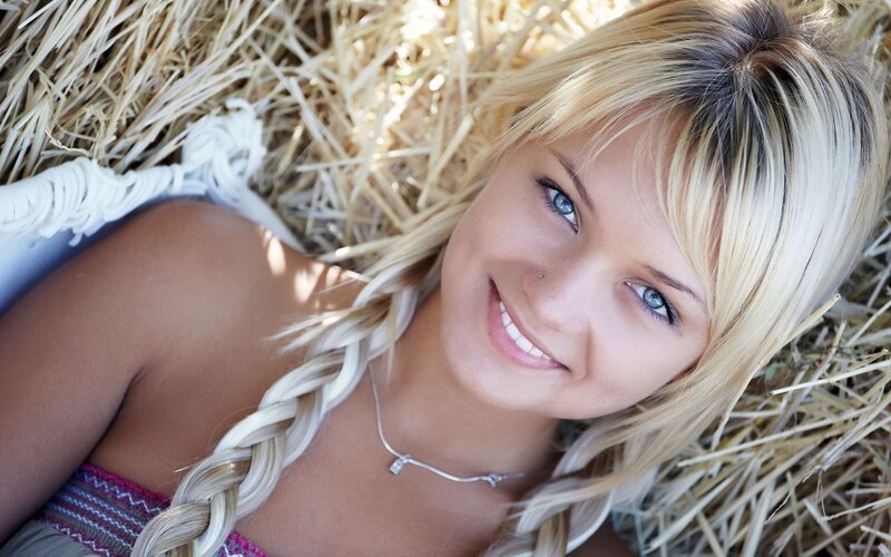 Blonde woman on hay bale