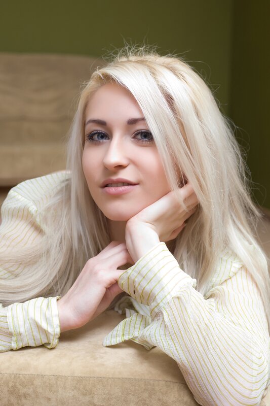 blonde woman resting on couch