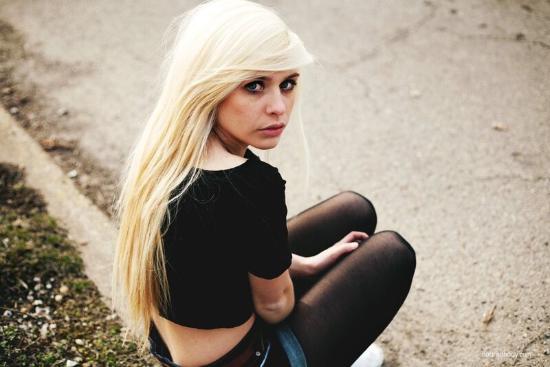 blonde woman sitting on ground