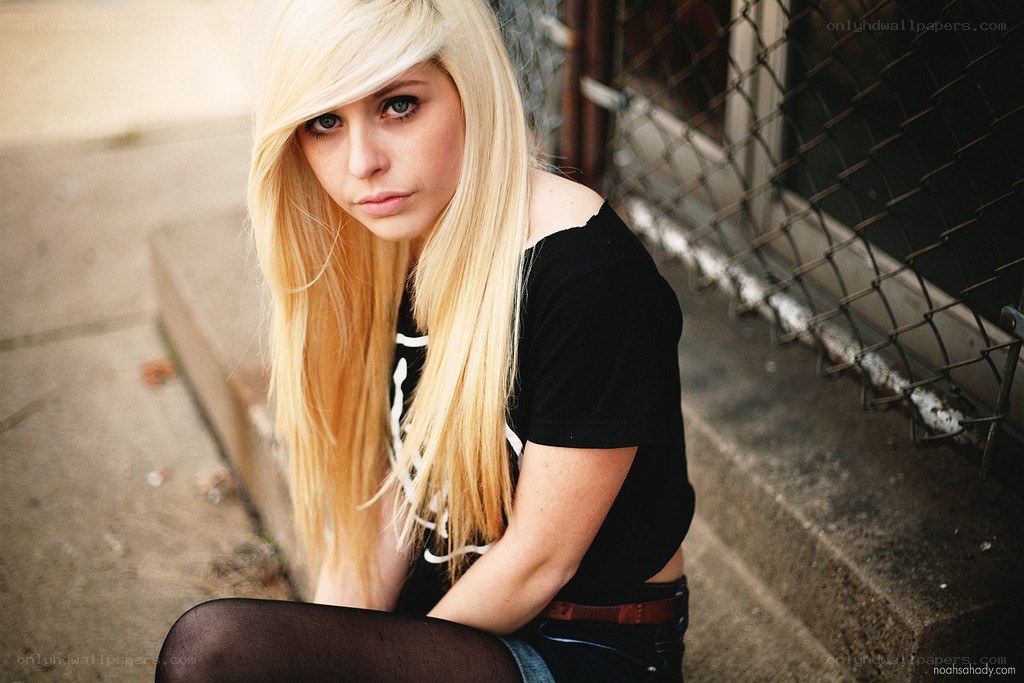 blonde woman sitting on steps