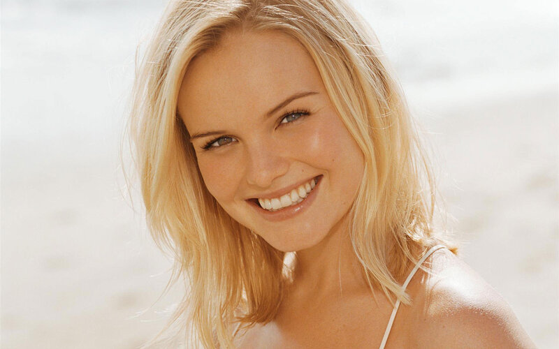 blonde woman smiling at beach