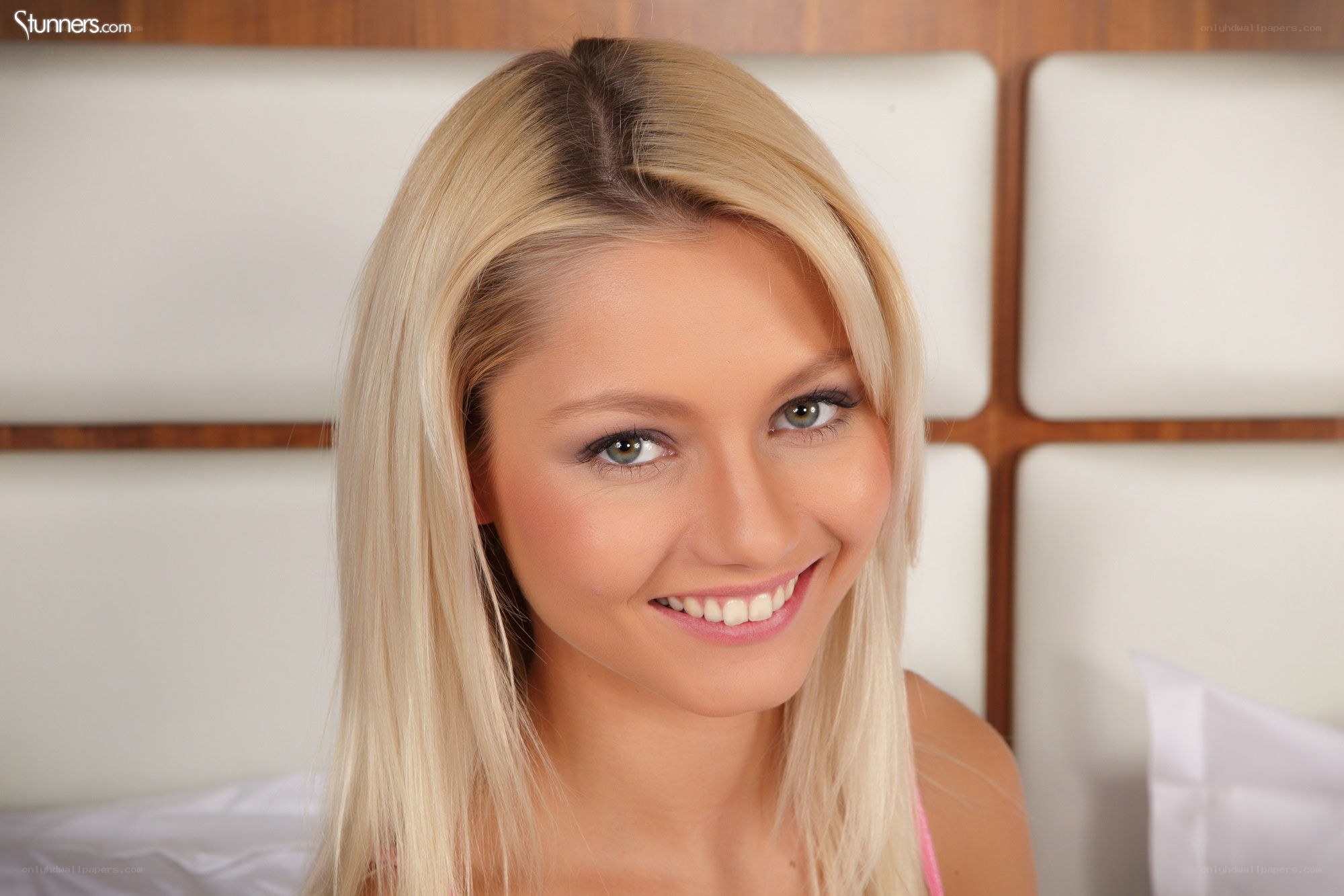 blonde woman smiling in bed