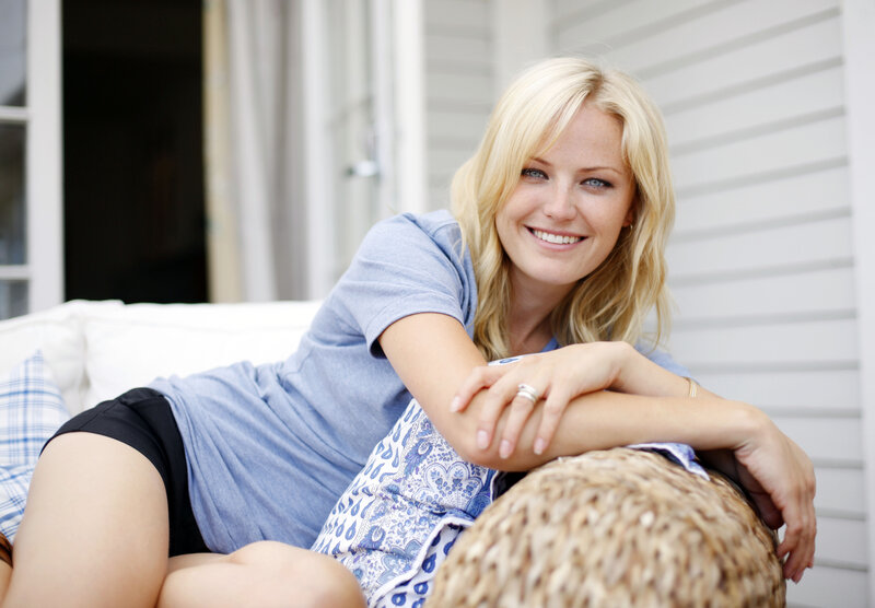 Blonde woman smiling on couch