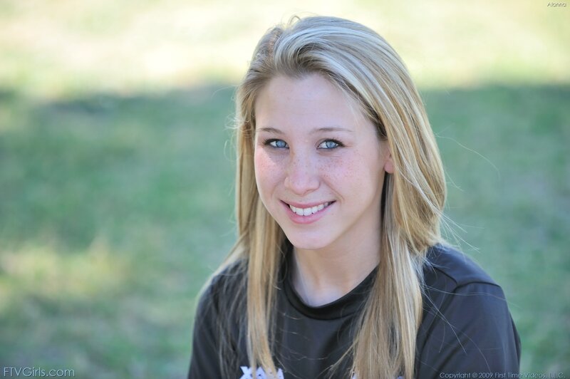 blonde woman smiling outdoors