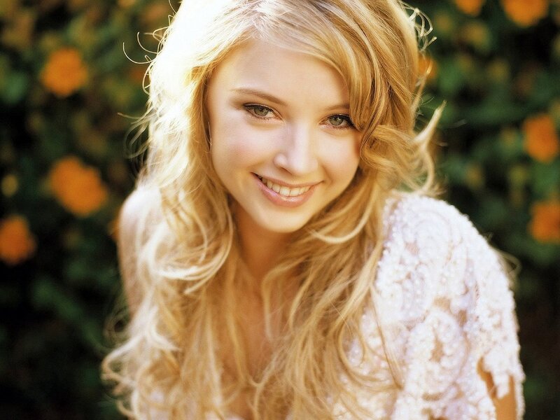 blonde woman smiling outdoors