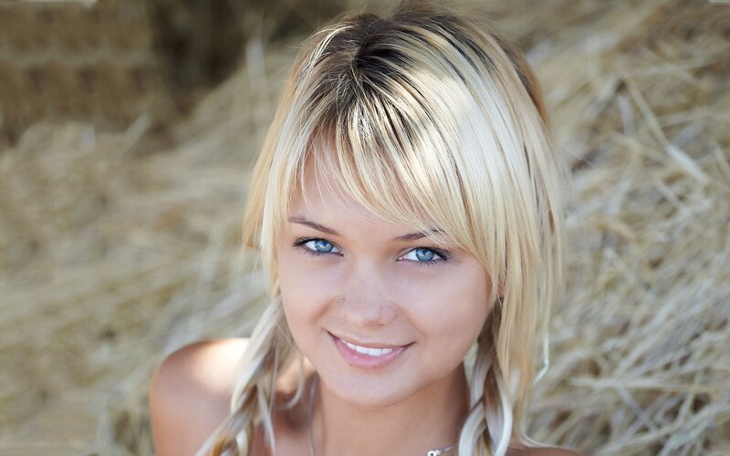 blonde woman smiling outdoors