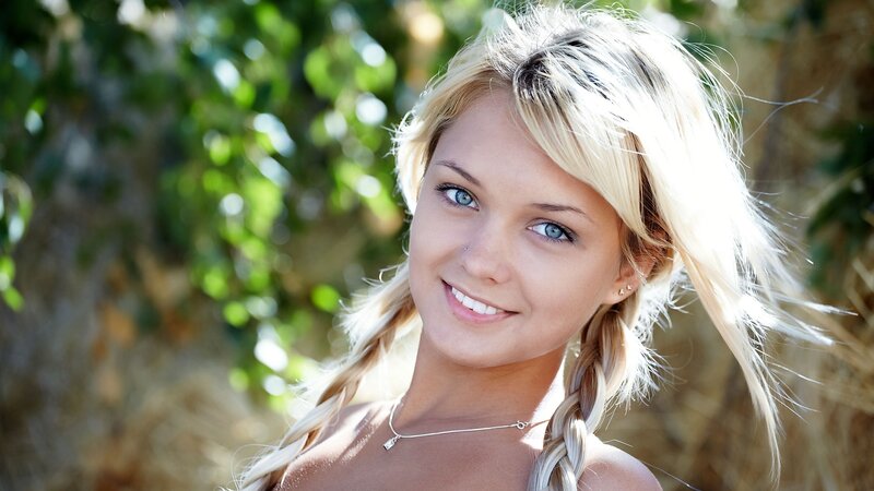 blonde woman smiling outdoors