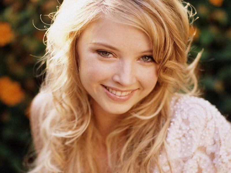 blonde woman smiling outdoors