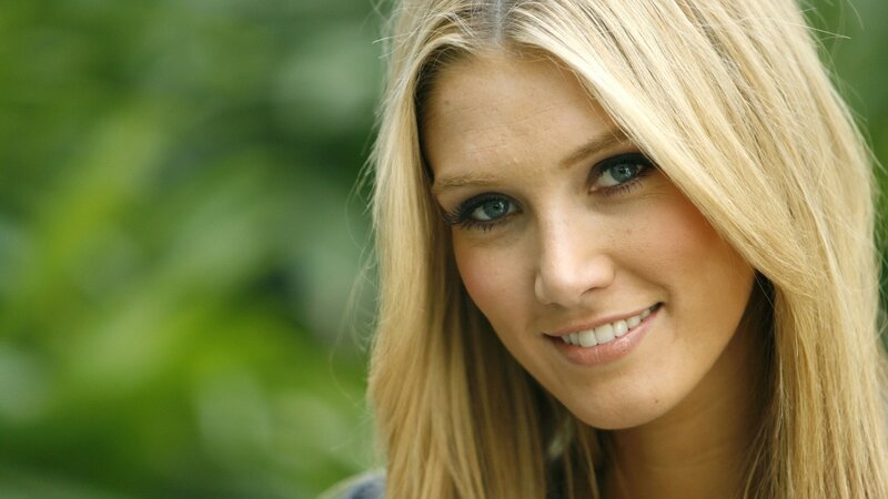 blonde woman smiling outdoors