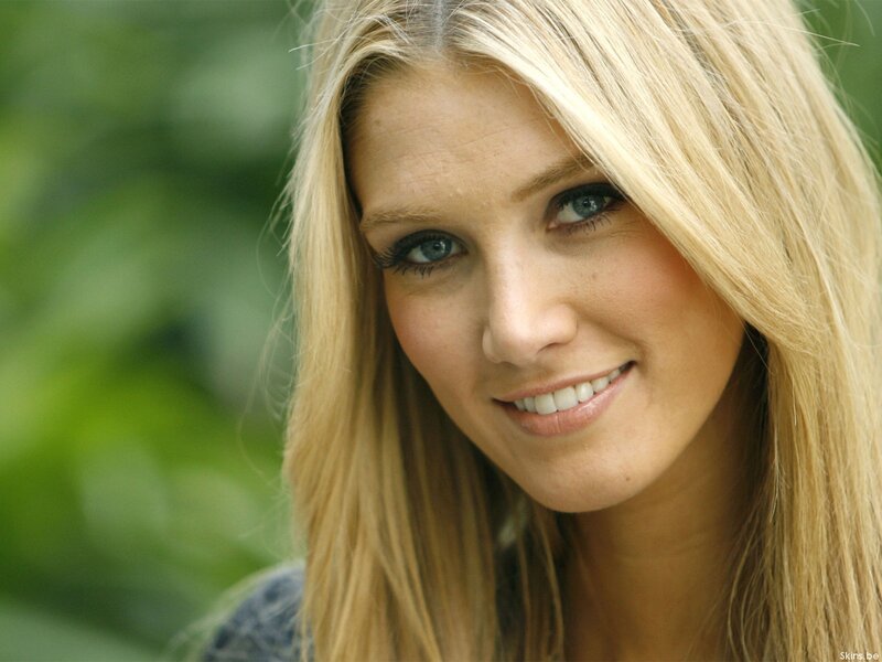 blonde woman smiling outdoors