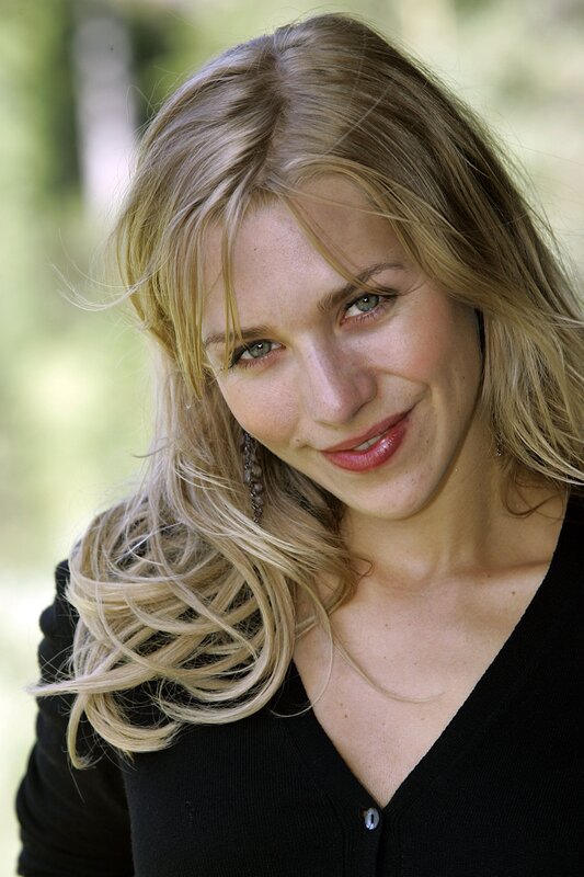 blonde woman smiling outdoors